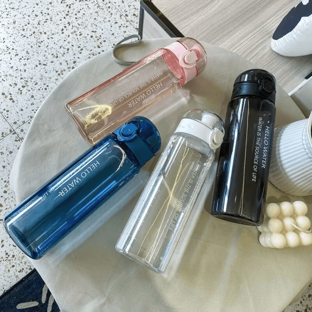 Four colorful eco-friendly water bottles with time markers for hydration